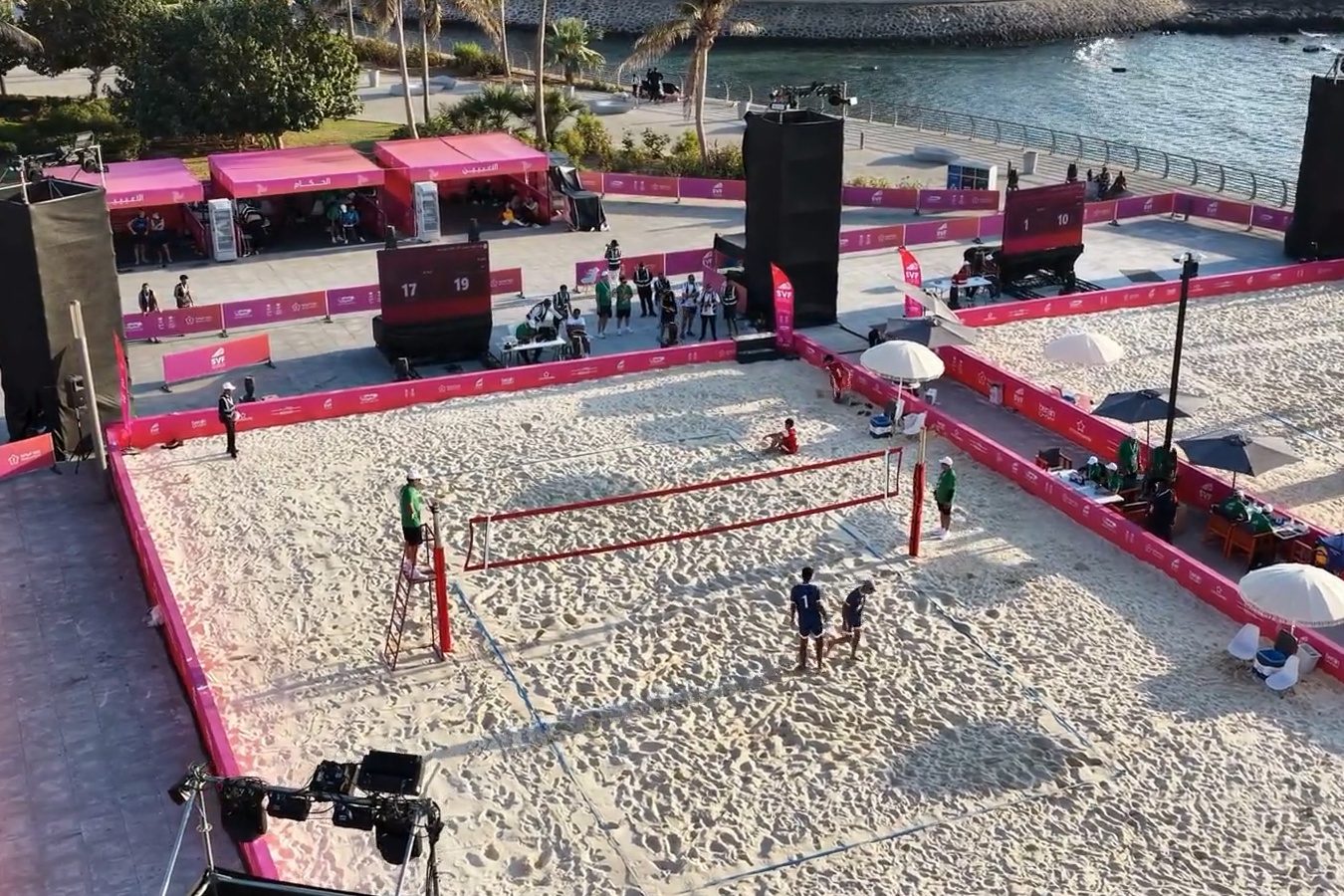 Aerial view of a sports arena with branded perimeter boards and structures